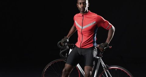 Confident African American Cyclist Against Black Background