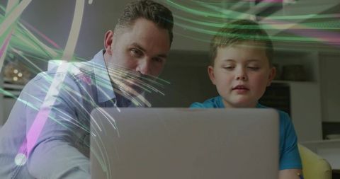 Father and Son Learning on Laptop at Home with Colorful Light Trails, Technology and Bonding
