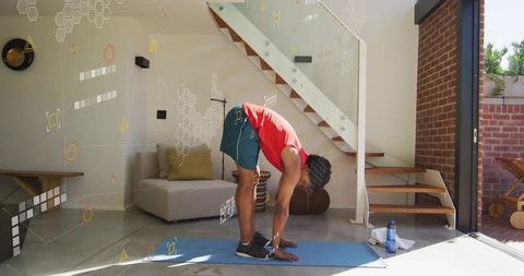 Man Practicing Flexibility on Mat in Modern Living Area