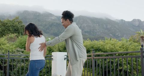 Women Playing Outdoors with Mountain View in Background