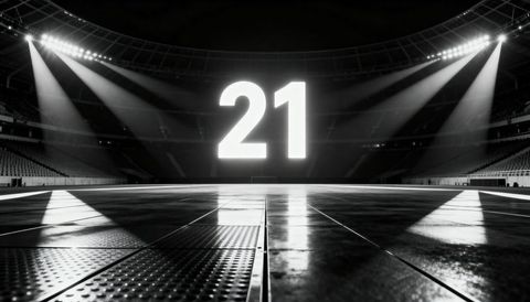 Glowing numeral 21 over empty arena floor with dramatic spotlights and symmetry