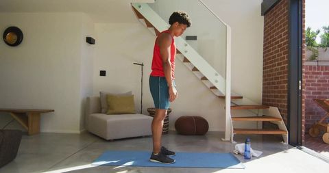 Man Practicing Yoga in Modern Living Room Interior