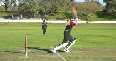 Female Cricket Player Batting in Action During Match