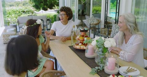 Women Enjoying Festive Outdoor Gathering with Desserts