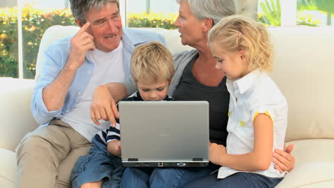 Multigenerational Family Enjoying Together Time on Laptop