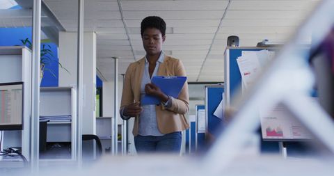 Businesswoman holding documents in modern office