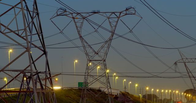 Time lapsed of electricity pylon near highway at dusk - Download Free Stock Photos Pikwizard.com
