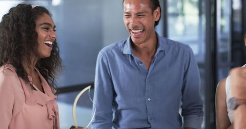 Diverse colleagues sharing laughter and conversation at work