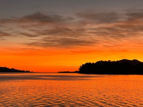 Vibrant sunset over tranquil beach waters