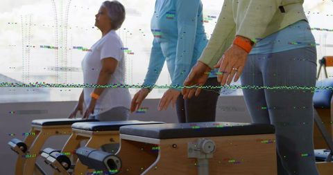 Senior women exercising on wooden pilates chairs for strength balance and mobility