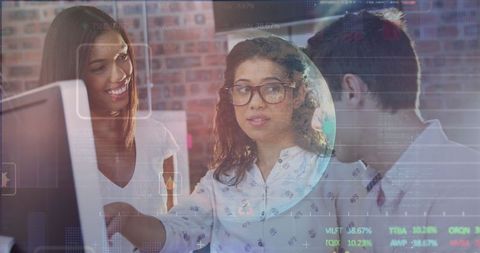 Diverse Team Collaborating Over Data in Modern Tech Environment