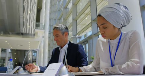 Multiracial Professionals at Business Seminar with Notepads