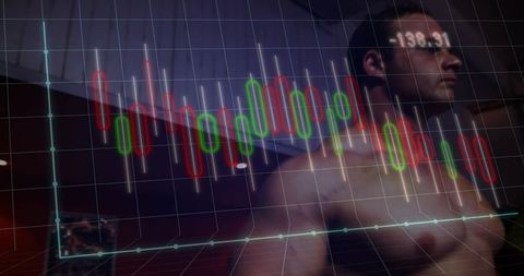 Standing shirtless man watching candlestick trading chart overlay in dim bedroom -138.31
