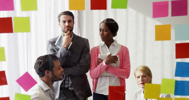 Diverse Team Collaborating with Colorful Sticky Notes in Modern Office - Download Free Stock Images Pikwizard.com