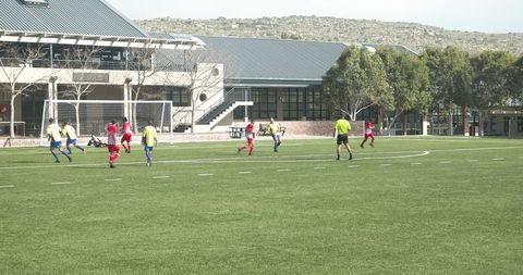 Grassroots soccer game: youth athletes showcase teamwork