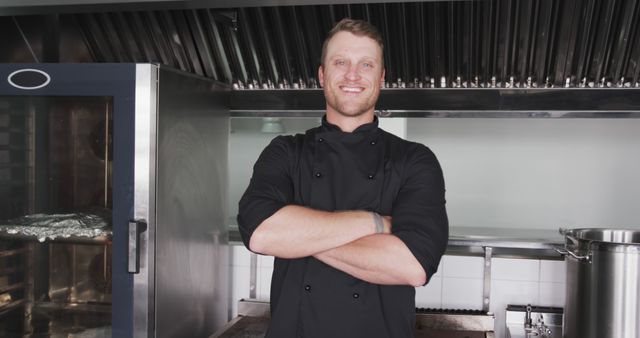 Confident Chef Standing in Restaurant Kitchen with Arms Crossed, Smiling - Download Free Stock Images Pikwizard.com