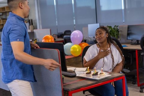 Coworkers Celebrating Birthday with Cupcakes in Office