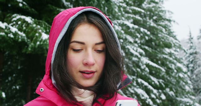 Woman in Red Winter Coat Using Smartphone in Snowy Forest - Download Free Stock Images Pikwizard.com