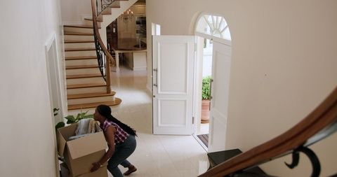 Couple Moving With Boxes Into New Stylish Home Entrance