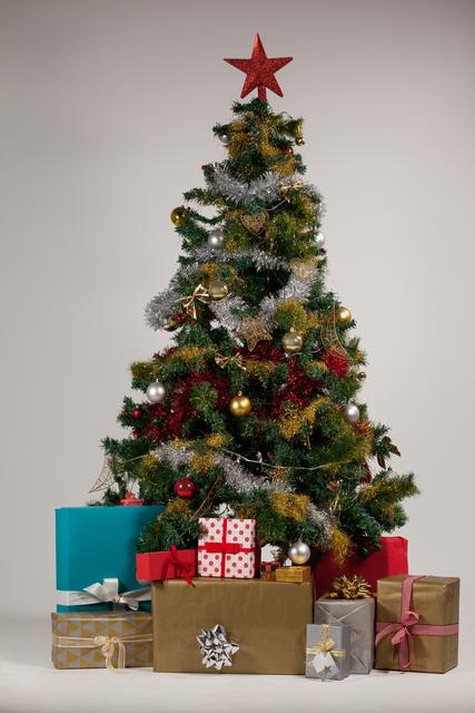 Various presents and christmas tree arranged on white background - Download Free Stock Photos Pikwizard.com
