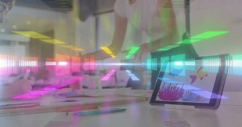 Creative team collaborating around tablet with colorful neon overlays and sketching tools