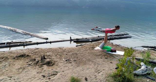 Couple Practicing Acro Yoga on Beach by Lake - Download Free Stock Images Pikwizard.com