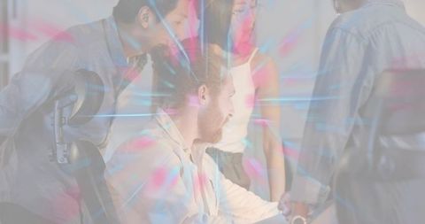 Colleagues shaking hands during team meeting with neon light overlay, modern office vibe