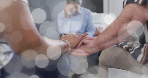 Holding hands seniors offering comfort and companionship in support group circle