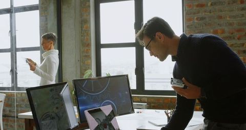 Engineers Collaborating with Technology in Modern Office