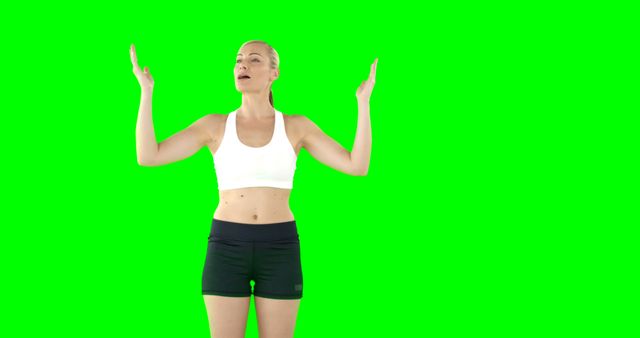 This image features a woman in sportswear stretching and exercising in front of a green screen background, making it ideal for fitness and health promotions. The green screen background allows for easy customization and insertion into various settings. Perfect for use in workout tutorials, gym advertisements, or health and wellness campaigns.