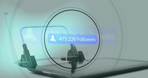 Displaying 473,226 followers notification over glossy tablet using glass magnifier