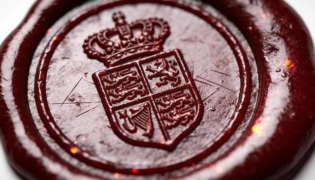 Red wax seal embossed royal crest and crown macro closeup texture for vintage branding