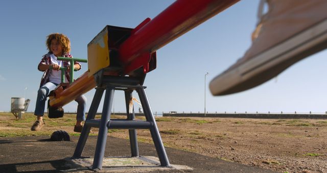 Mother Playing with Joyful Son on Seesaw in Sunlit Playground - Download Free Stock Images Pikwizard.com