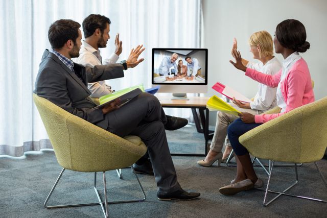 Business professionals engaged in a video conference meeting, showcasing modern technology and remote collaboration. Ideal for illustrating corporate communication, teamwork, and digital workplace solutions.