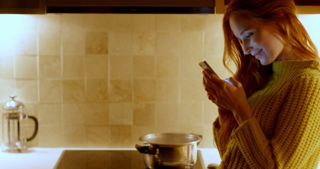 Young Redhead Woman Cooking at Home and Using Smartphone - Download Free Stock Images Pikwizard.com