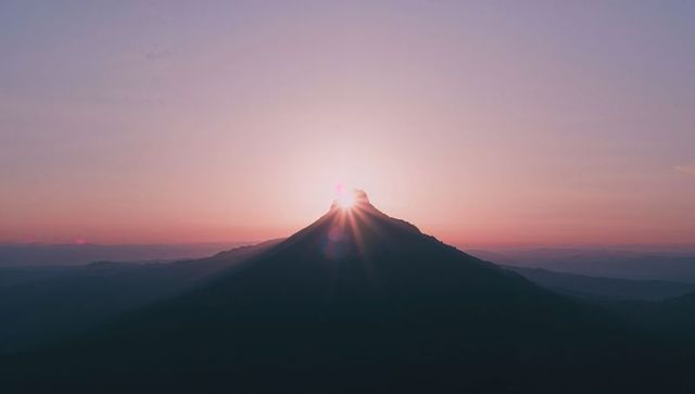 Solitary Mountain Peak Illuminated by Sunrise Glow