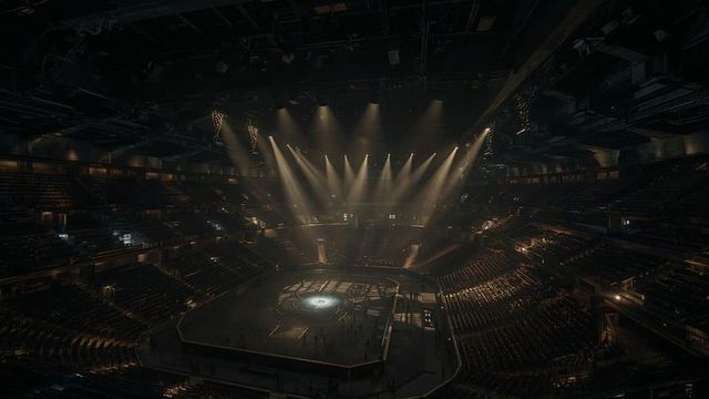 Vibrant arena with octagonal stage and spotlights