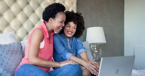 African American Women Chatting on Laptop in Living Room