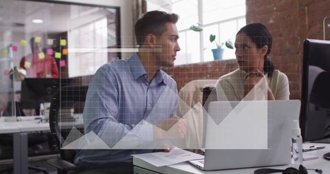 Business Team Analyzing Data with Graph Overlays in Modern Office