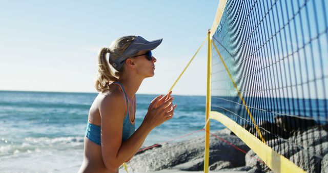 Woman Preparing for Beach Volleyball Game by the Sea - Download Free Stock Images Pikwizard.com