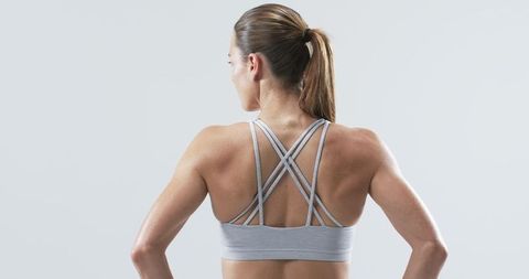 Athletic Woman Posing Confidently with Strong Back Muscles