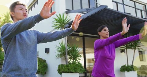 Couple Practicing Yoga Outdoors in Natural Setting