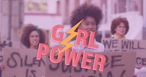 Empowered Women with Banners Promoting Girl Power Movement