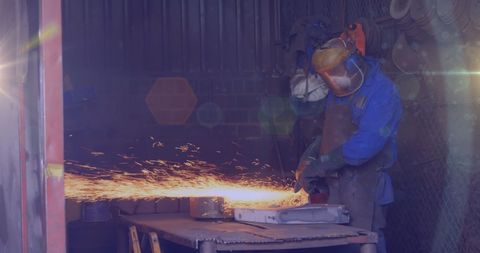Skilled Workshop Worker Grinding Metal with Sparks Flying