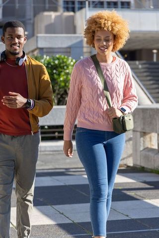 African american friends walking in urban plaza enjoying sunny casual city stroll