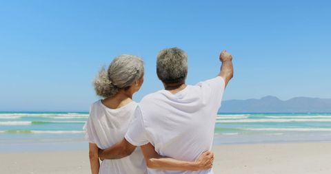Senior Couple Enjoying Sunny Day at Beach