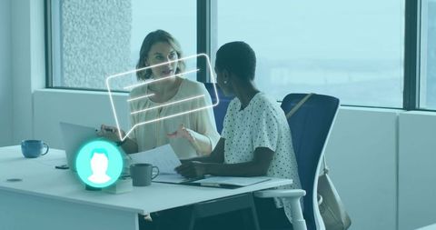 Professional Women Collaborating on Project in Office Setting