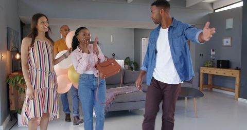 Joyful Friends Arriving at Party, Exchanging Gifts Indoor
