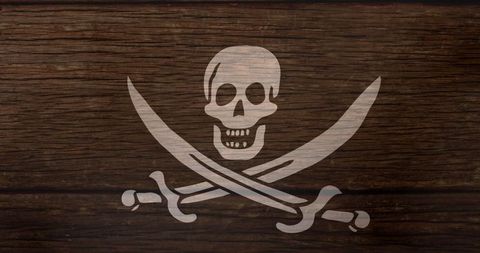 Jolly roger skull and crossed swords on wooden texture
