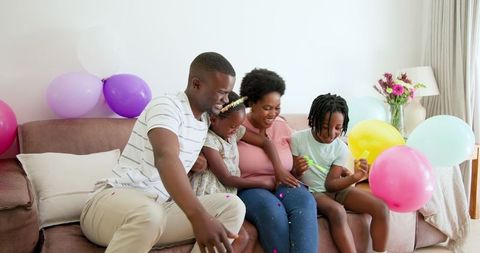 Joyful African American Family Celebrating at Home Together